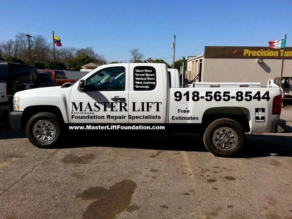 White Chevrolet service truck with Master Lift Foundation branding and contact details