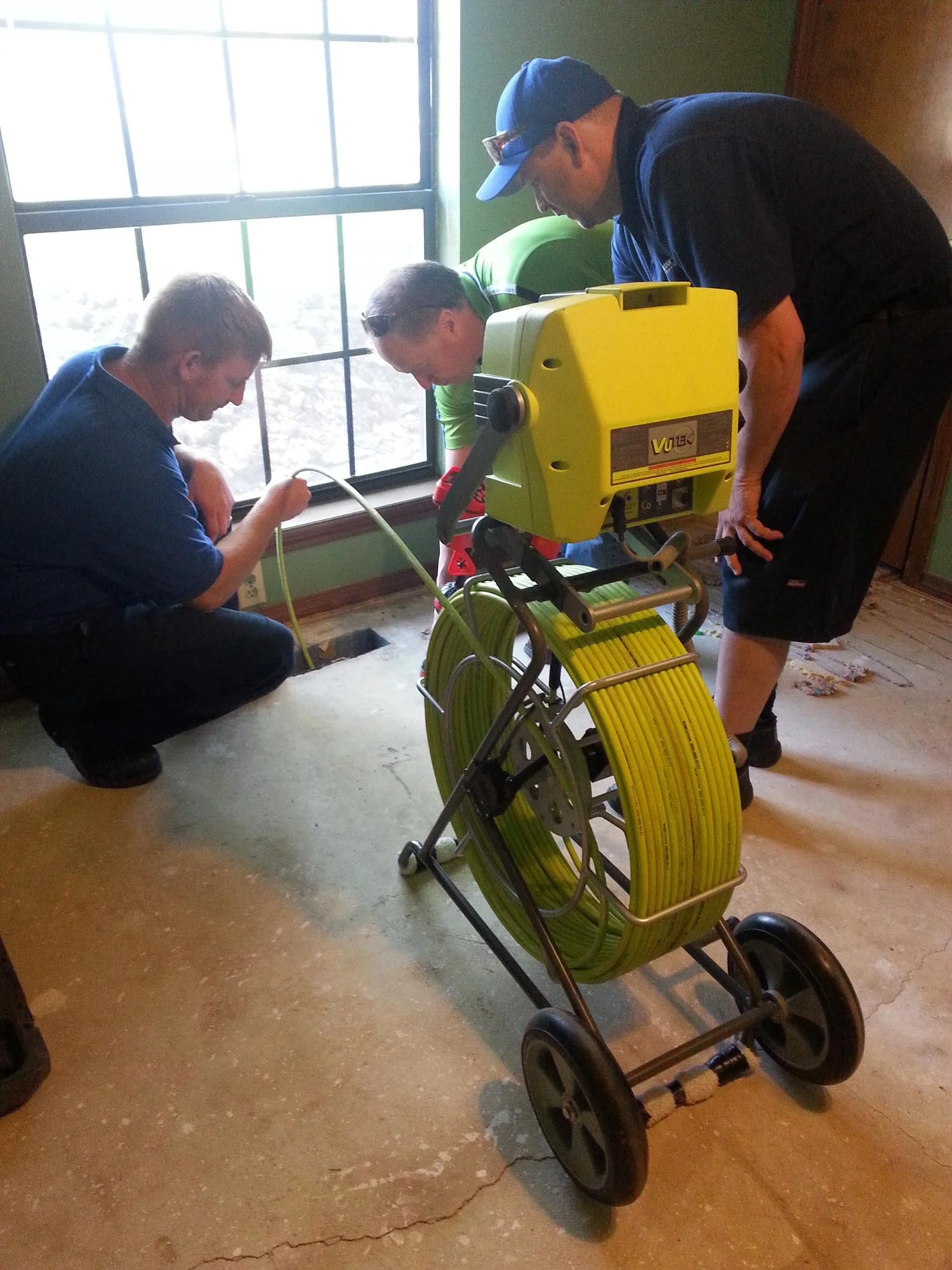 Foundation inspection team using diagnostic equipment to assess home foundation condition