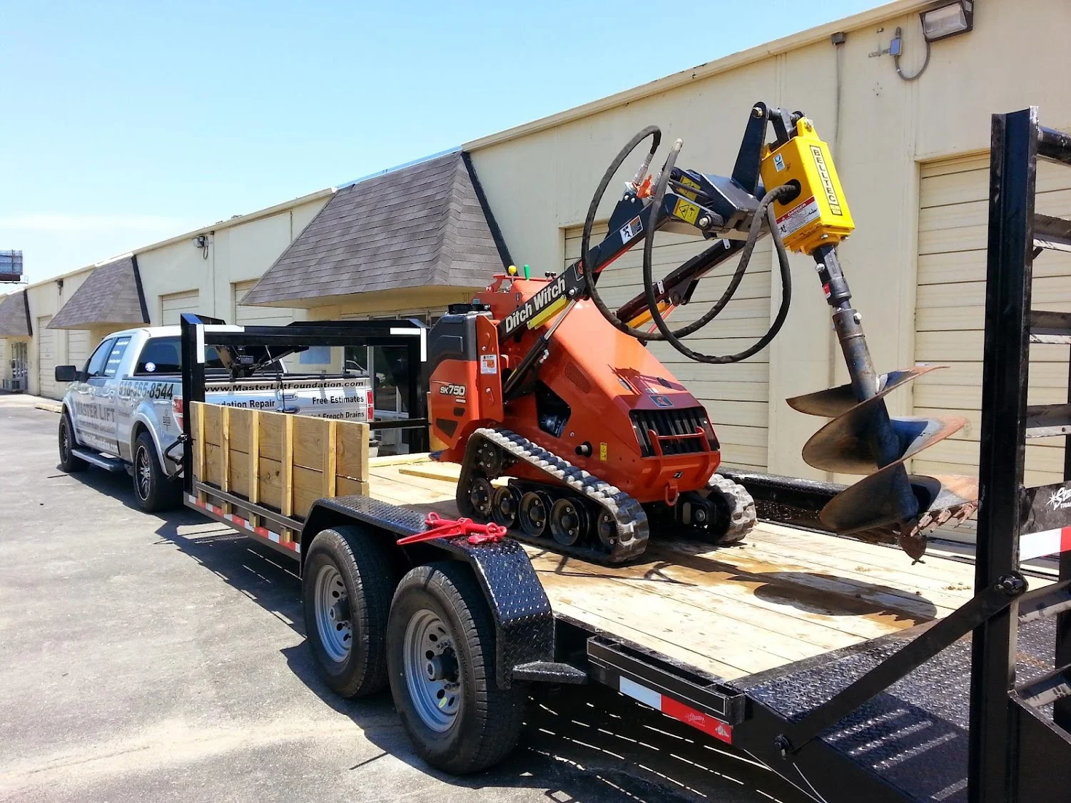 Hydraulic foundation repair equipment on trailer at Tulsa job site