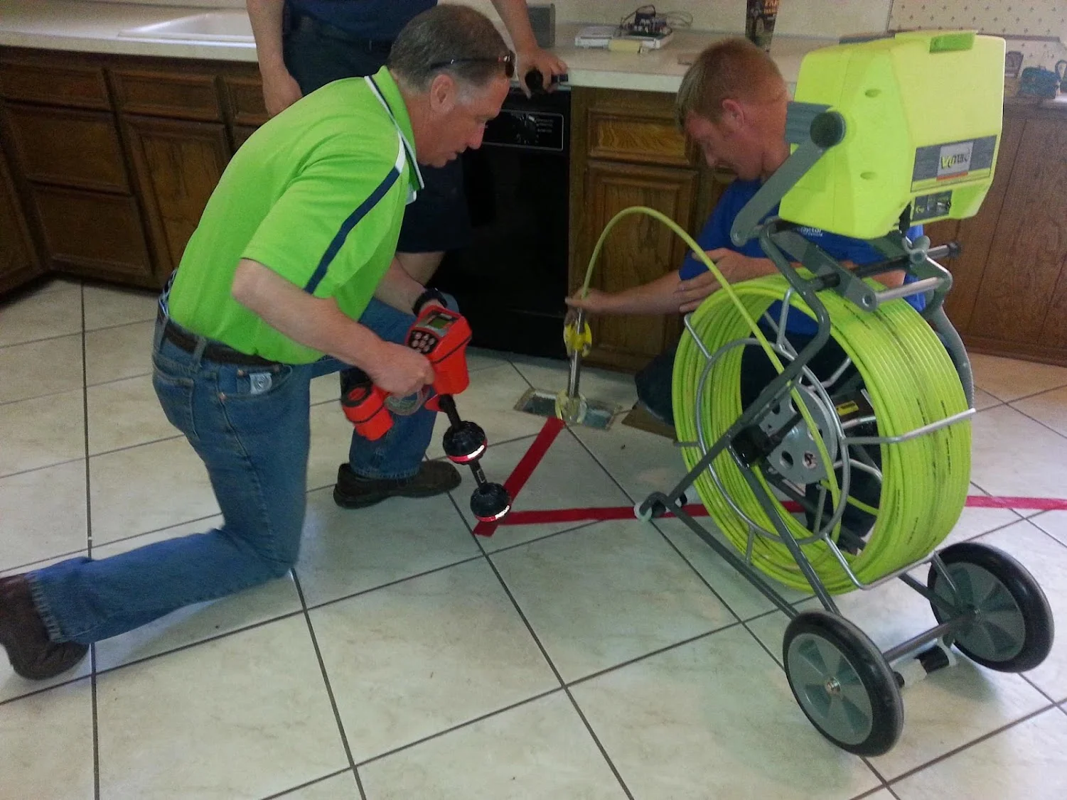 Foundation inspection team using diagnostic equipment on residential foundation