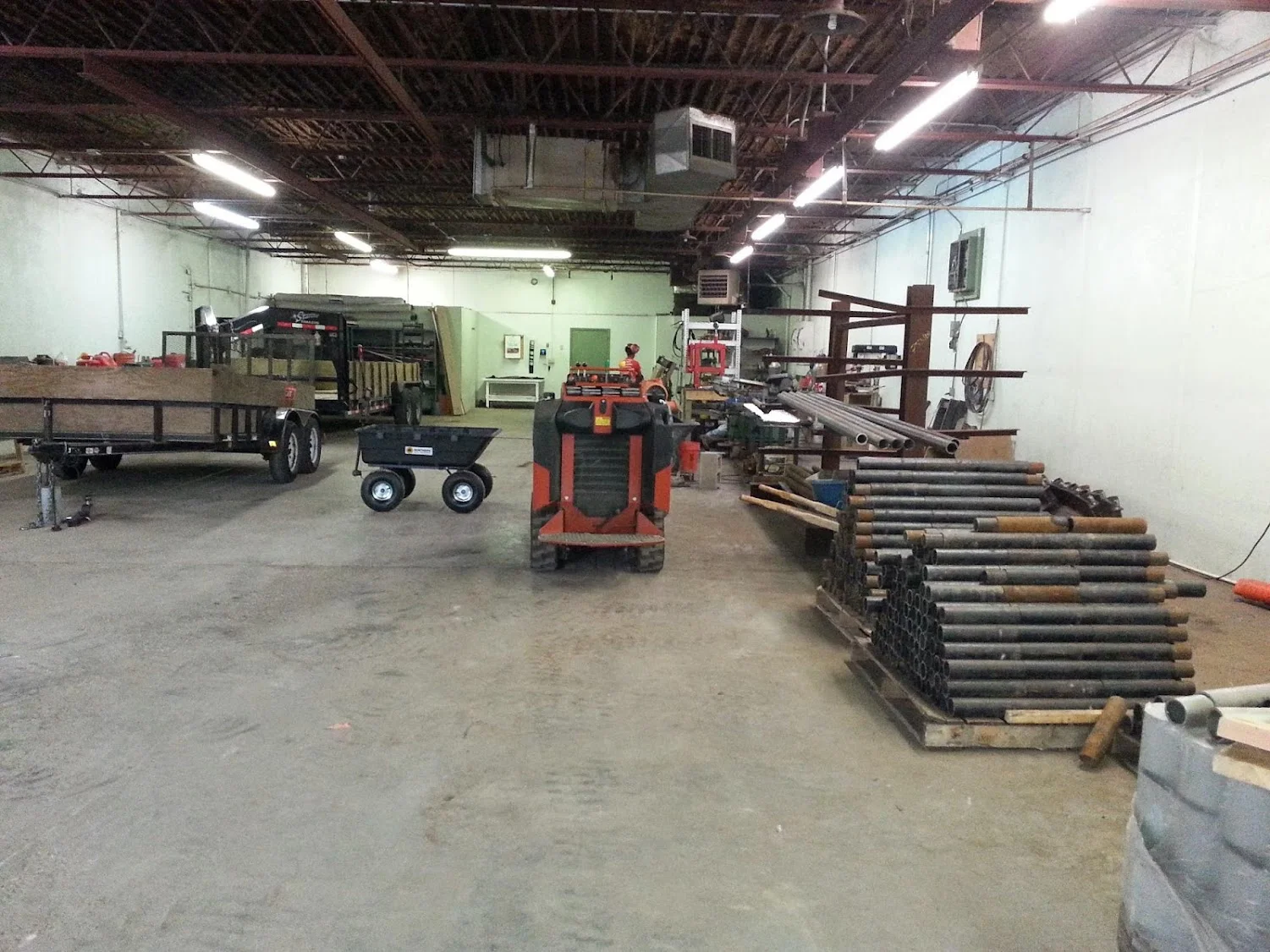 Foundation repair equipment facility with hydraulic lifts, steel posts, and materials